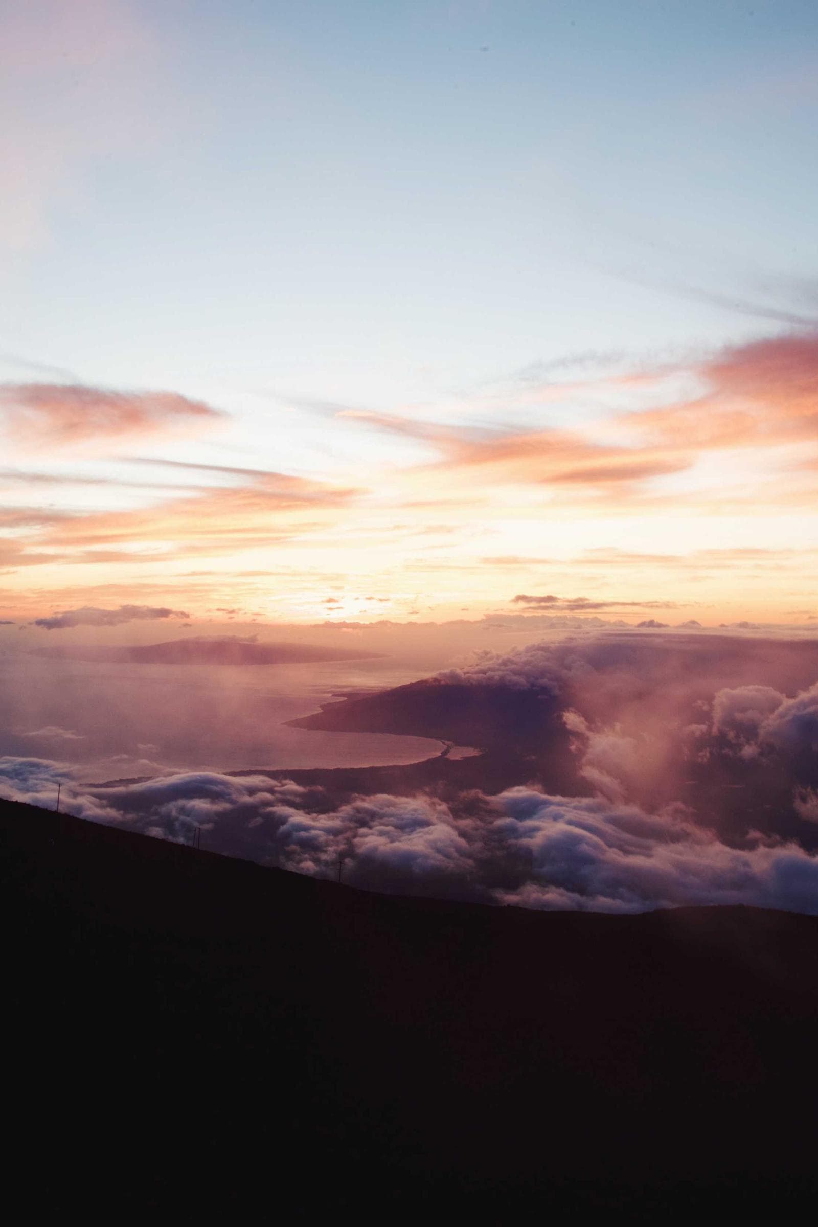 Misty Mountain Sunrise — First light spills over layered peaks wrapped in morning fog.